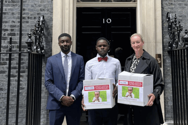 GCN's Christian Weaver, Awaab Ishak's father Faisal and Kelly Darlington stand with the Awaab's Law petition outside 10 Downing Street