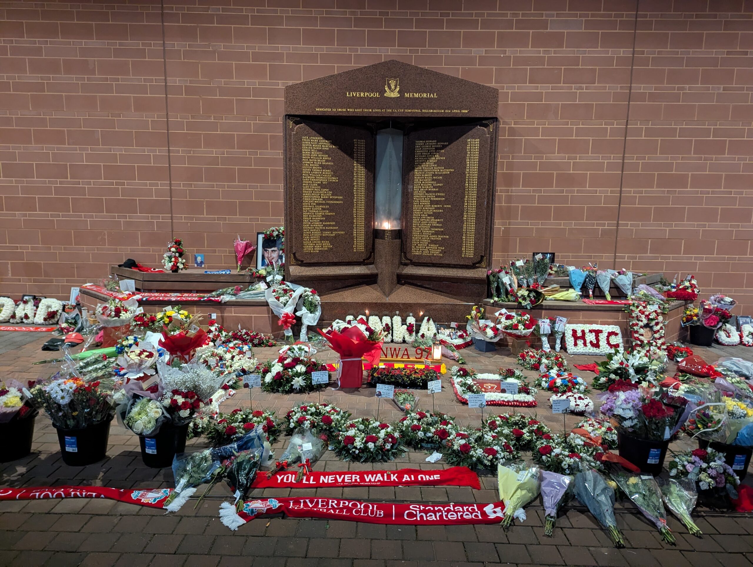 Wreaths and tributes to the 97 at the Hillsborough Memorial outside Anfield Stadium in Liverpool, on 15 April, 2025. Credit: Alex Blair / Garden Court North Chambers.
