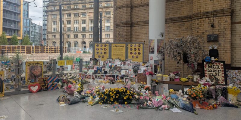 Tributes are laid for the 22 victims of the Manchester Arena bombing at Manchester Victoria Station, following a minute's silence on 22 May 2025. Credit: Alex Blair / Garden Court North Chambers.